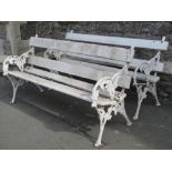 A pair of 19th century garden benches with slatted seats and blackberry pattern cast iron ends