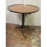A Georgian mahogany occasional table, the circular dished top 60cm diameter, raised on a vase shaped