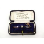 Edwardian diamond set bar brooch in unmarked yellow metal, in a period box, 2.9g