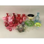 A collection of 19th century and later cranberry glassware to include moon flasks and Mary Gregory