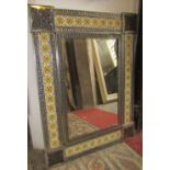 A decorative Moroccan style wall mirror with tin and ceramic panelled framework, 85 x 65cm