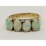 14ct opal ring set with four oval stones in raised setting, size K, 2.7g