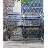 A set of four steel framed folding garden terrace chairs with stained wooden slatted seats and backs