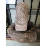 An early carved stone mortar/quern of square form with central circular tapered cut out, together