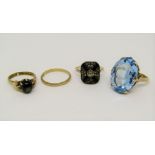 Four gold rings; a 10k cats eye example and three 9ct examples comprising a blue paste set ring,