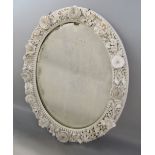 19th century blanc de chine porcelain oval wall mirror, decorated with various delicate flower work,