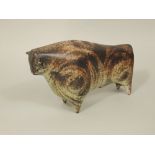 A Peter Wright studio pottery model of a stylised bull with brown glazed finish and with incised