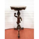 A 19th century jardiniere or lamp stand, the carved figural column support raised on scrolling