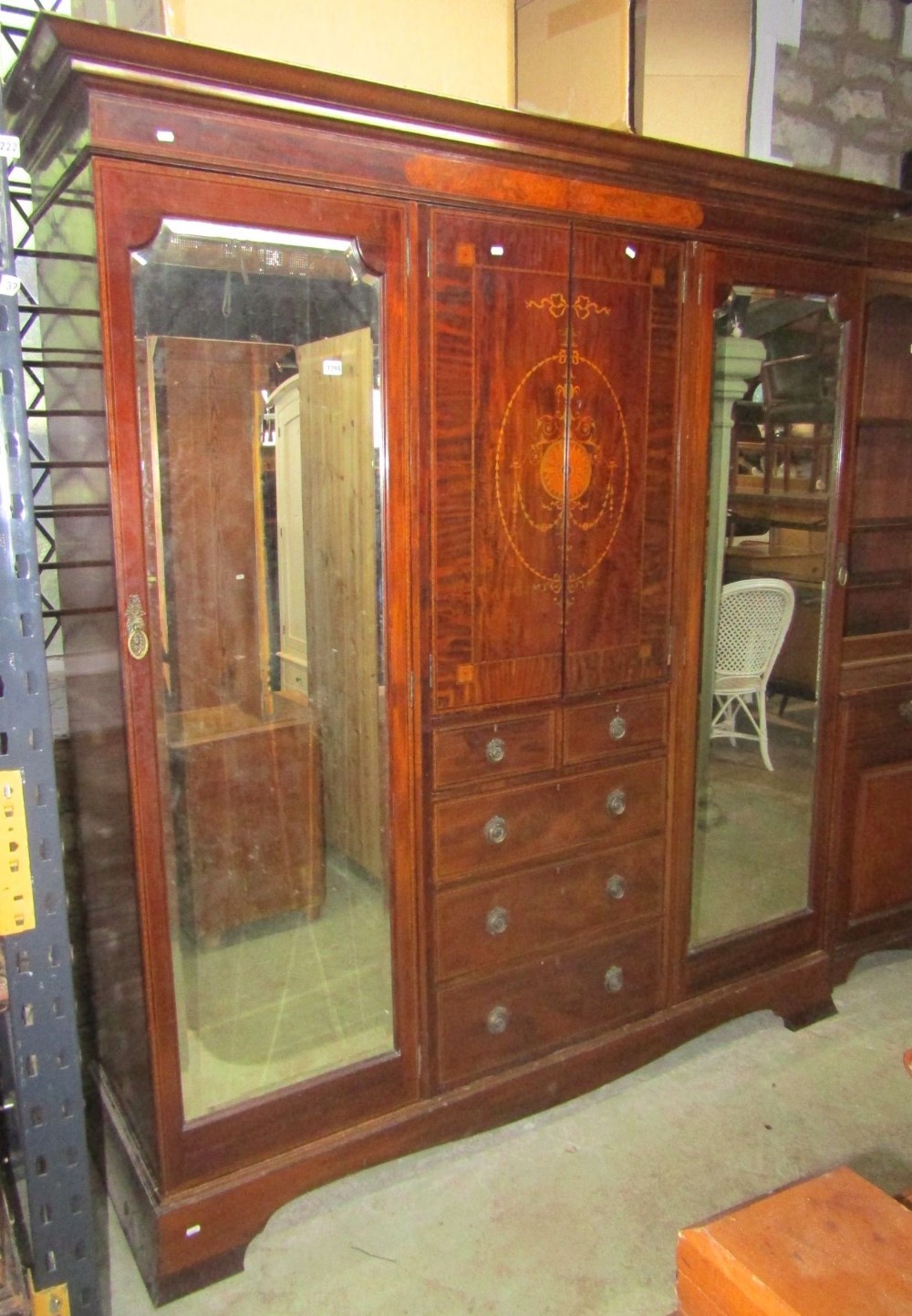 A good quality inlaid Edwardian mahogany triple compactum wardrobe, the central section enclosed