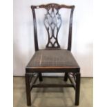 A set of four good quality Chippendale revival mahogany dining chairs with pierced vase shaped