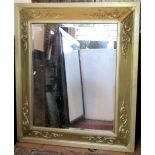 A 19th century wall mirror of rectangular form, the cushion moulded frame with applied scrolling