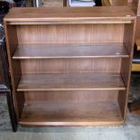 An Ercol Golden Dawn elm open bookcase with two adjustable shelves over a recessed plinth with