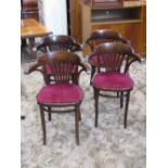 A set of four stained beechwood framed Bentwood cafe chairs with upholstered pad seats and pierced