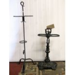 A reproduction cast iron two divisional umbrella stand with foliate detail, together with a