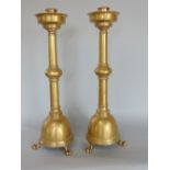 Good quality pair of cast brass ecclesiastical candlesticks, on three paw feet, 44cm high (2)
