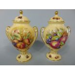 A pair of Aynsley Orchard Gold pattern two handled vases and covers, 23 cm