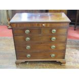 A Georgian mahogany chest of three long and two short drawers with brass fittings and raised on ogee