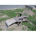 A weathered contemporary teak folding steamer type chair with slatted seat, back and foot rest,