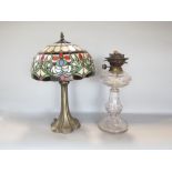 Tiffany style leaded glass table lamp, the shade decorated with typical scrolled foliage upon a