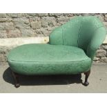 A small/short chaise lounge, the raised back with shaped outline and green ground floral patterned