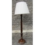 A Georgian style walnut standard lamp, with partially reeded stem and stepped disk shaped platform