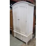 A contemporary white wood domed top wardrobe enclosed by a pair of panelled doors, over two short