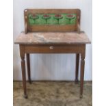 An Edwardian oak wash stand with veined marble top and raised splashback incorporating four Art