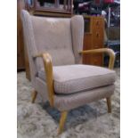 A Howard Keith Bambino armchair with upholstered seat and wing back over open shaped forms and