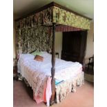 A Georgian mahogany four poster bedstead, complete with drapes, the foot posts in the Hepplewhite