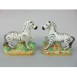 A pair of 19th century Staffordshire models of Zebra, 19cm tall approx