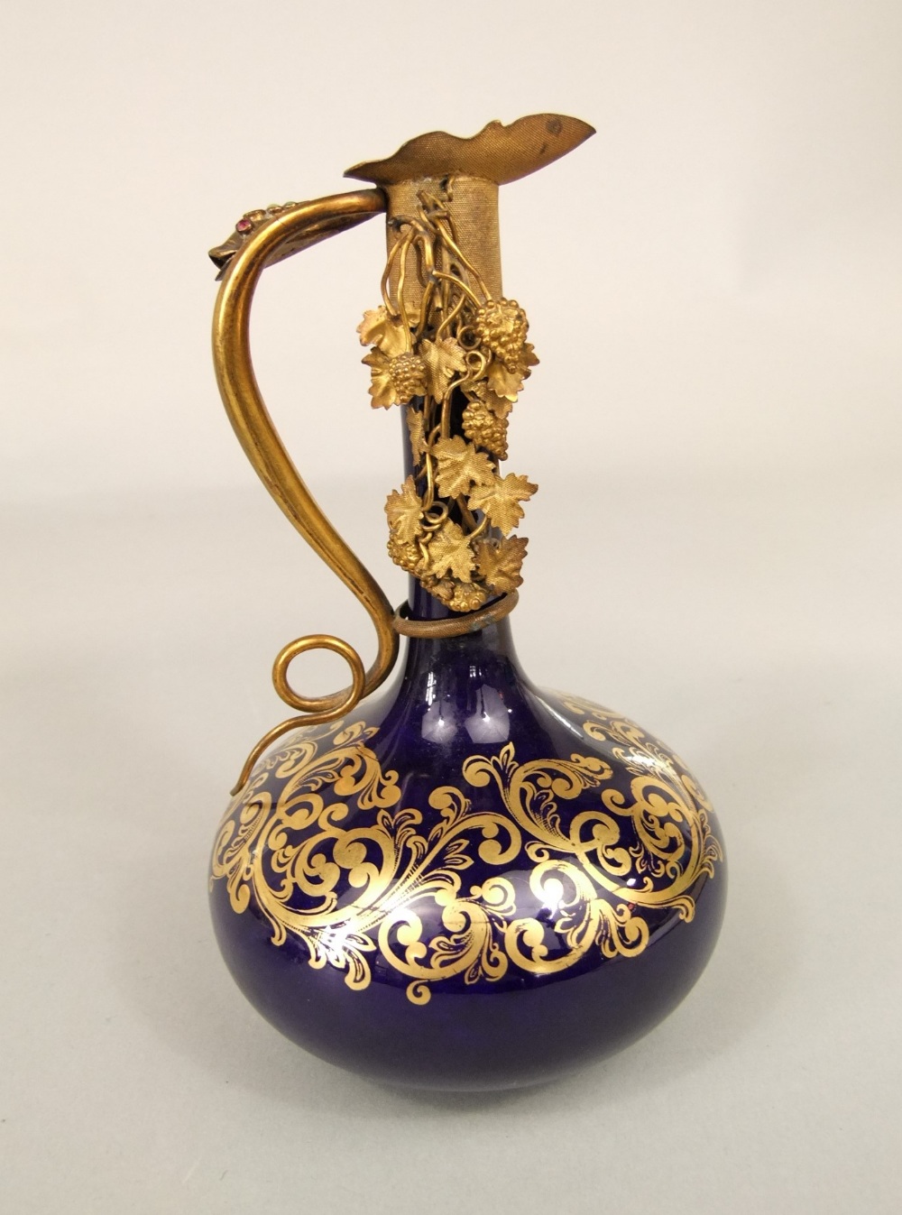 An unusual 19th century blue ground ewer with slender neck, gilded scrolling detail and ornate - Image 4 of 5