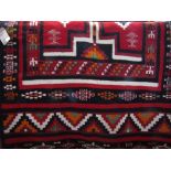 Interesting African flat weave runner with bold red and medallion design upon a black ground, 250