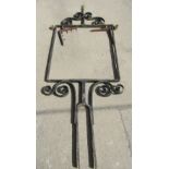 A large wrought iron exterior sign frame with scroll work detail and spiral finial, 254cm high x