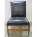 A single retro chair with black vinyl upholstered seat and back raised on stained beechwood