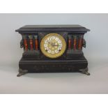 Interesting American wooden black slate style twin train mantel clock, the architectural case with