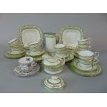 A collection of Aynsley teawares with green and gilt border decoration, comprising pair of cake