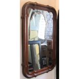 A 19th century wall mirror of rectangular form with shaped and moulded oak frame in the Gothic