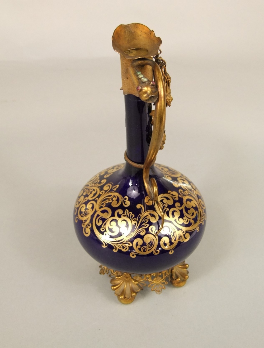 An unusual 19th century blue ground ewer with slender neck, gilded scrolling detail and ornate - Image 2 of 5