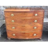 A Regency mahogany bow fronted chest of four long graduated drawers with crossbanded detail,