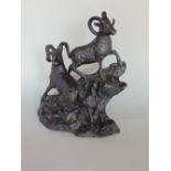 Ebonised cast brass/bronze study of two mountain goats on a naturalist base, 20cm high