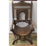 A 19th century Moorish elbow chair, the carved framework with repeating geometric detail,