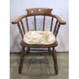 A Windsor elm and beechwood smokers bow elbow chair with turned spindle back