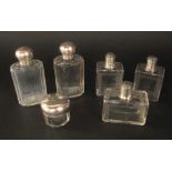Collection of white metal topped scent bottles to include a pair of oval faceted glass examples with