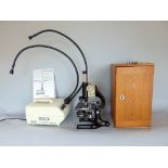 Cased Prior microscope with accessories, together with a further surgical type lamp (2)