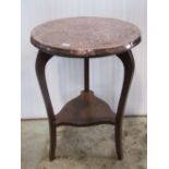 An Arts & Crafts style oak occasional table with circular overlaid hammered copper top raised on