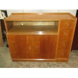 A White & Newton medium oak sideboard enclosed by an arrangement of four doors and tower of four