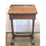 A vintage pitch pine child's school desk with ink well and hinged slope, together with a