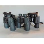 Three pairs of binoculars, two Yukon 7 x 50 and 10 x 50 types, plus a Russian 7.50 all with straps