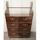 An unusual mahogany chest fitted with a side by side arrangement of eight drawers, with oval