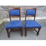 A set of six mid Victorian oak dining chairs with later upholstered seats and back panels, raised on